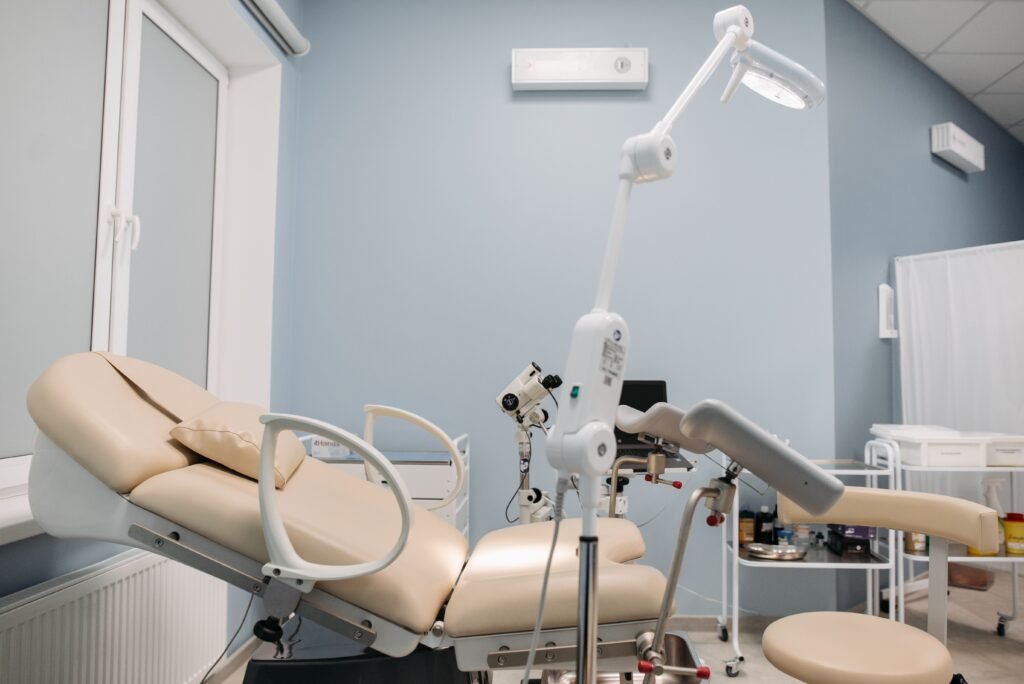 pexels-photo-7108389-7108389 Bright and clean interior of a modern clinic with medical equipment and examination table.